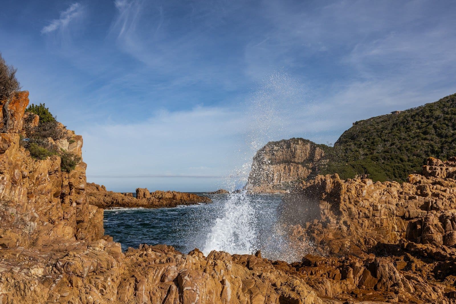 Surf breaking on the sandstone at the Heads